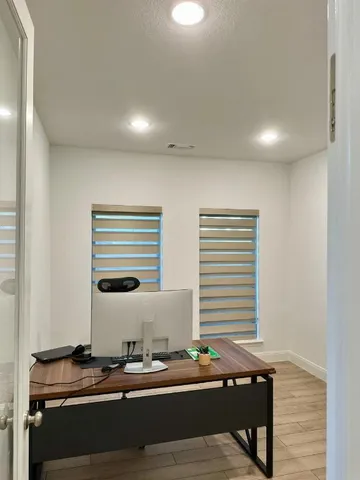 a view of a workspace with furniture