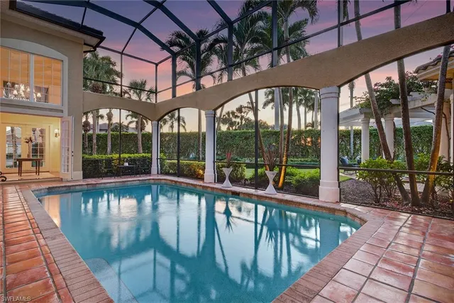 a dining room with furniture a rug and a chandelier