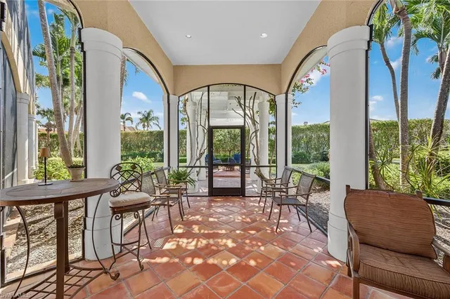 a view of a patio with a table chairs and a backyard