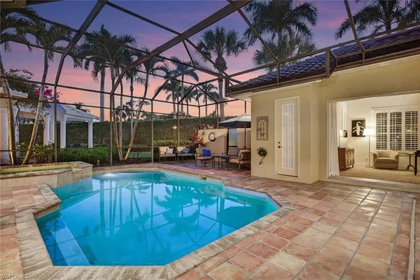 a view of a swimming pool with outdoor seating