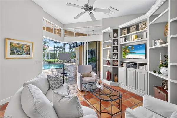 a living room with furniture cabinets and a window