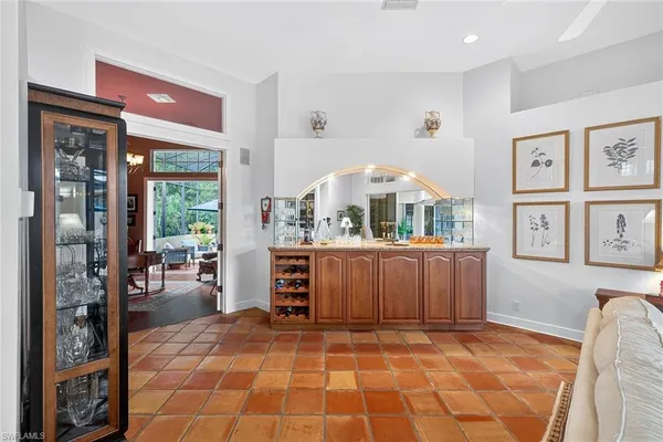 a kitchen with white cabinets and refrigerator