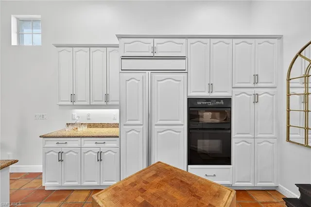 a kitchen with granite countertop a stove a sink and a granite counter tops