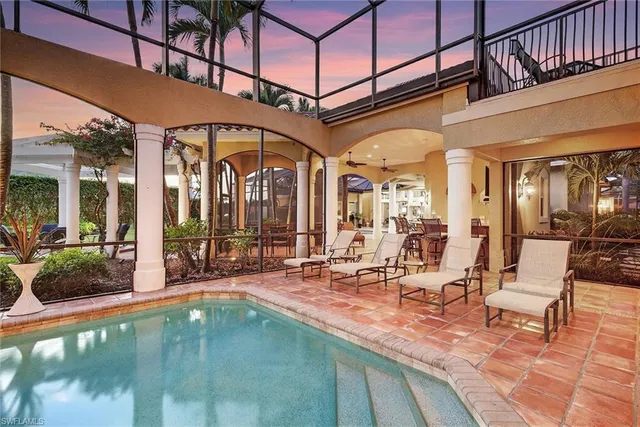 a view of a swimming pool with outdoor seating