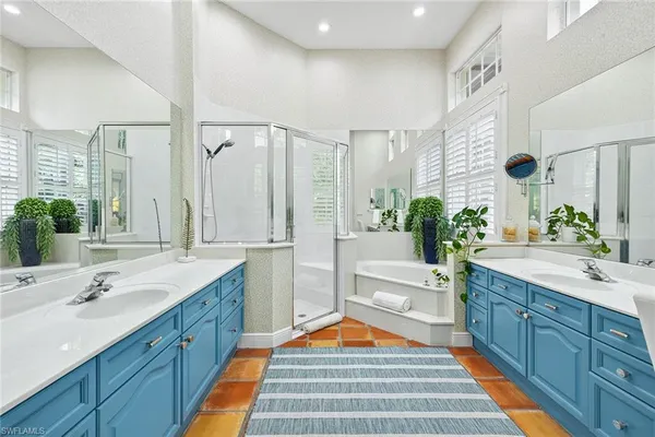 a living room with furniture chandelier and a large window