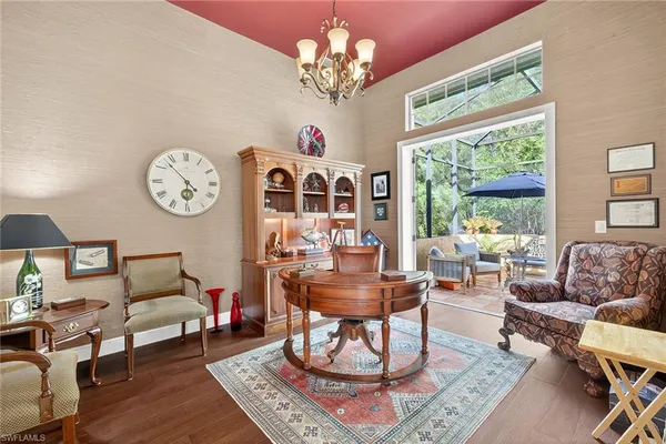 an outdoor sitting area with furniture and umbrella