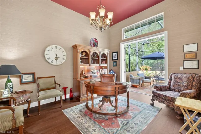 an outdoor sitting area with furniture and umbrella