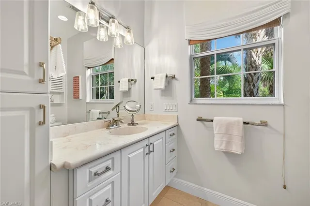 a spacious bedroom with a bed and a chandelier