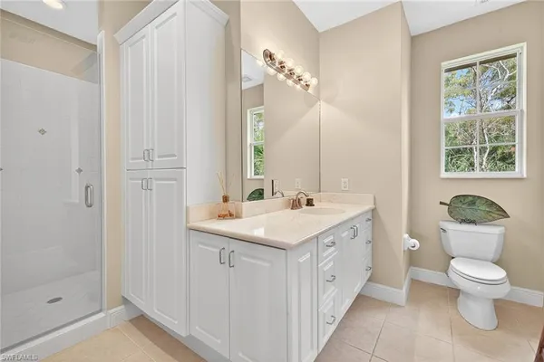 a spacious bedroom with a bed and ceiling fan