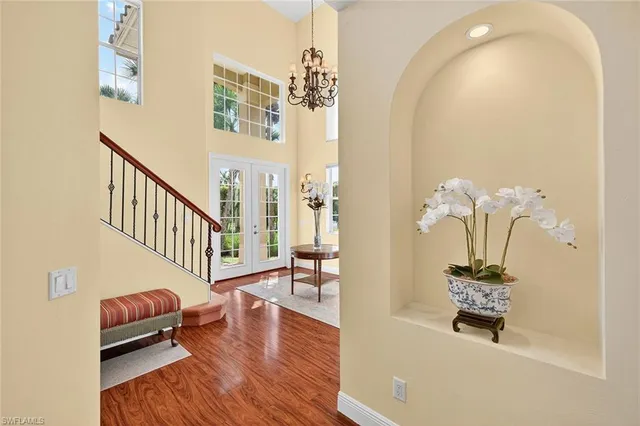 a hallway with wooden floor and furniture