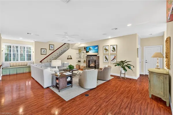 a living room with furniture and wooden floor
