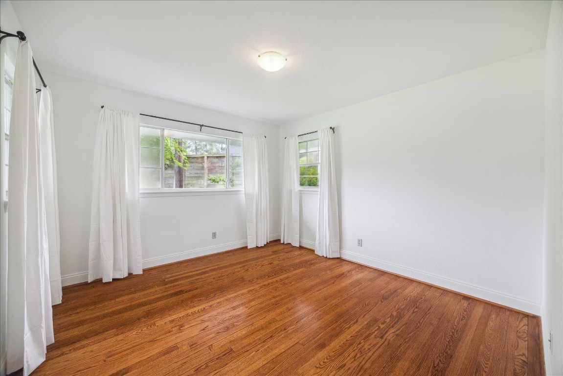 10 Pom Court Spring Valley Village, TX 77055 - Photo 22 of 27 a view of empty room with wooden floor and fan