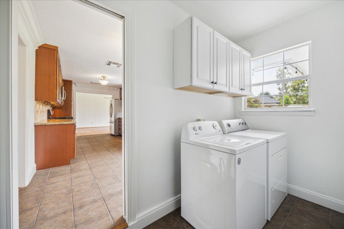 10 Pom Court Spring Valley Village, TX 77055 - Photo 25 of 27 a utility room with cabinets washer and dryer