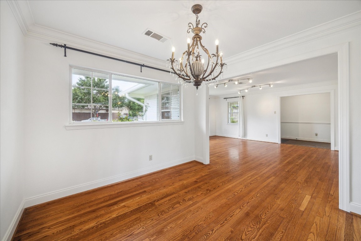 10 Pom Court Spring Valley Village, TX 77055 - Photo 7 of 27 a view of a room with wooden floor chandelier and windows