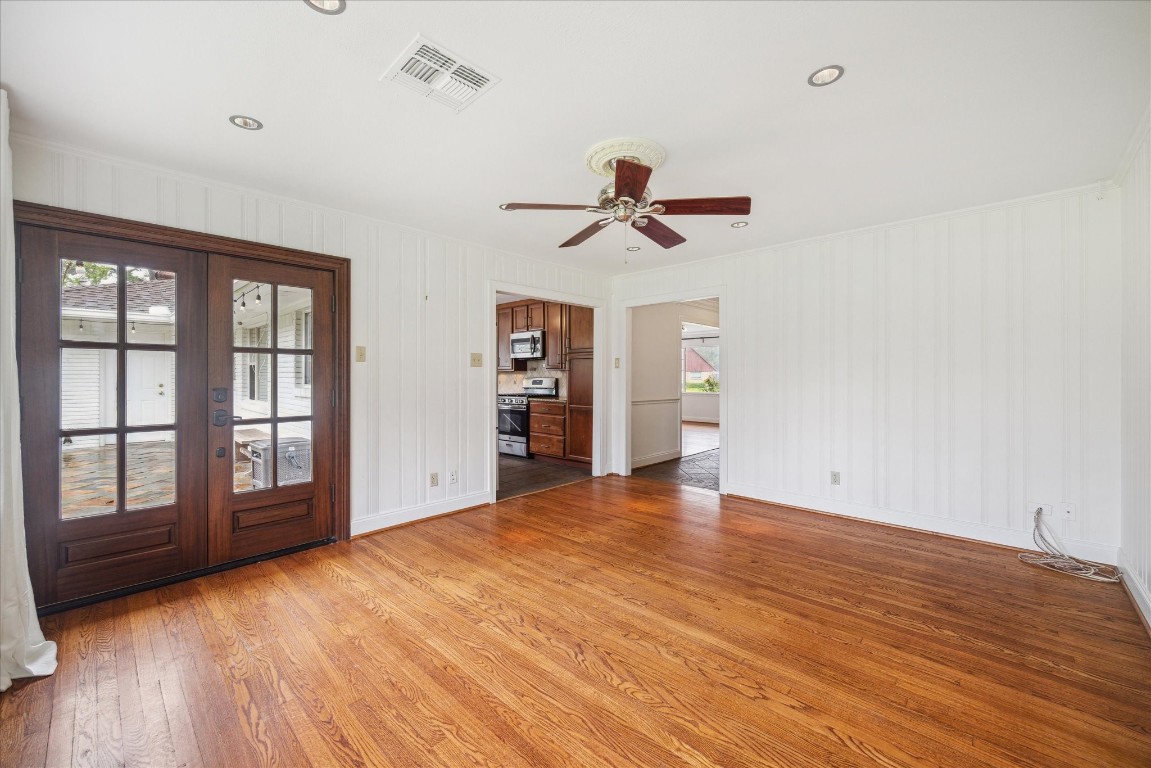 10 Pom Court Spring Valley Village, TX 77055 - Photo 8 of 27 a view of an empty room with a window and wooden floor