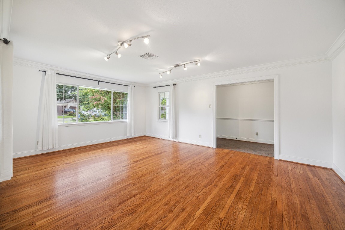 10 Pom Court Spring Valley Village, TX 77055 - Photo 10 of 27 an empty room with wooden floor and windows