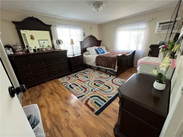 a bed room with two bed and a dresser
