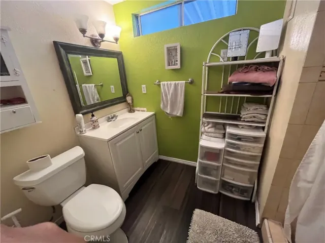a bathroom with a toilet and a mirror