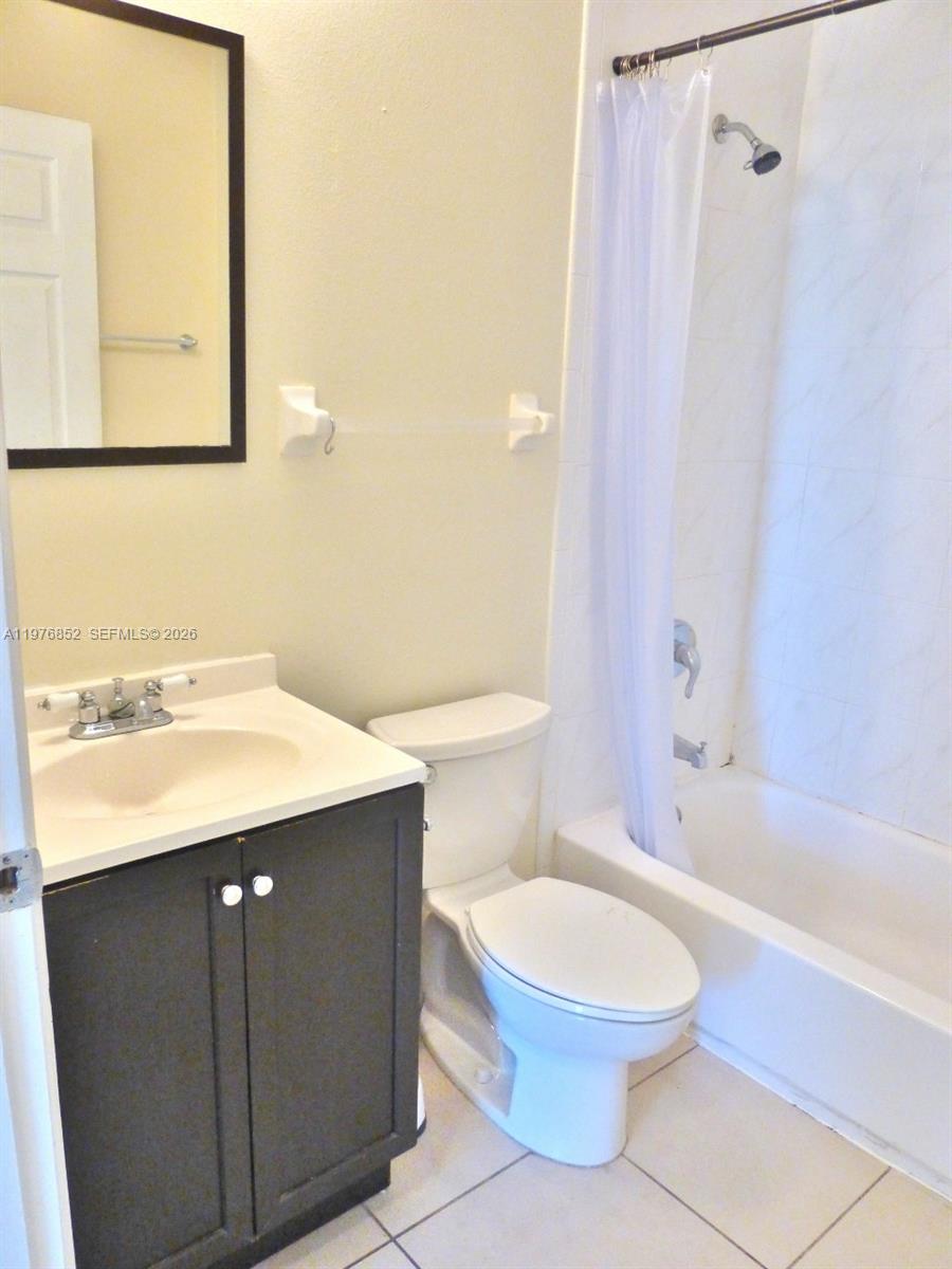 843 Southwest 13th Avenue, Unit 201 Miami, FL 33135 - Photo 4 of 6 a bathroom with a sink a toilet and shower