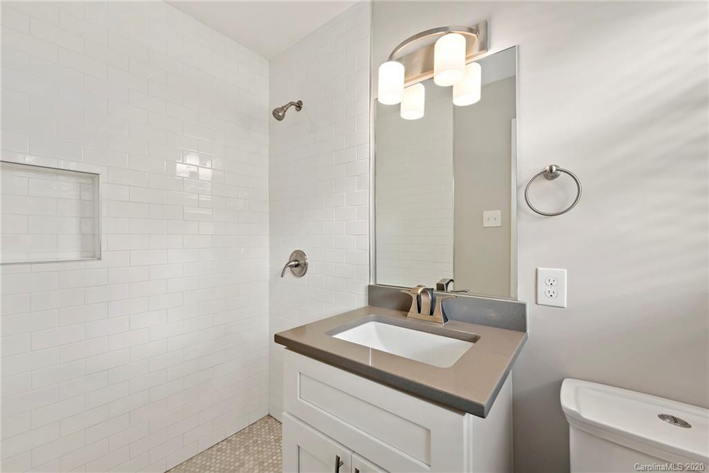 3115 Sudbury Road Charlotte, NC 28205 - Photo 11 of 17 a bathroom with a sink vanity and a mirror