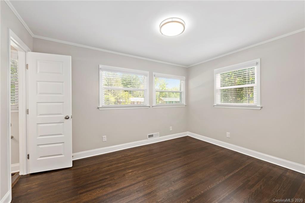 3115 Sudbury Road Charlotte, NC 28205 - Photo 12 of 17 an empty room with wooden floor and windows