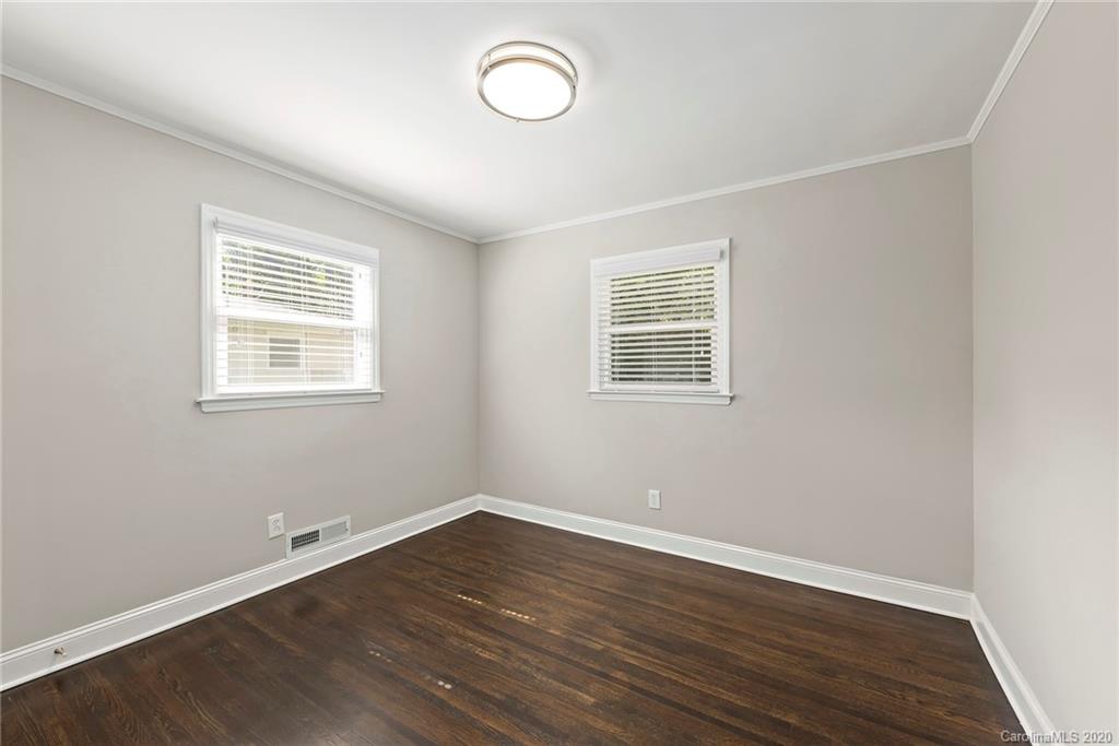 3115 Sudbury Road Charlotte, NC 28205 - Photo 14 of 17 an empty room with wooden floor and windows