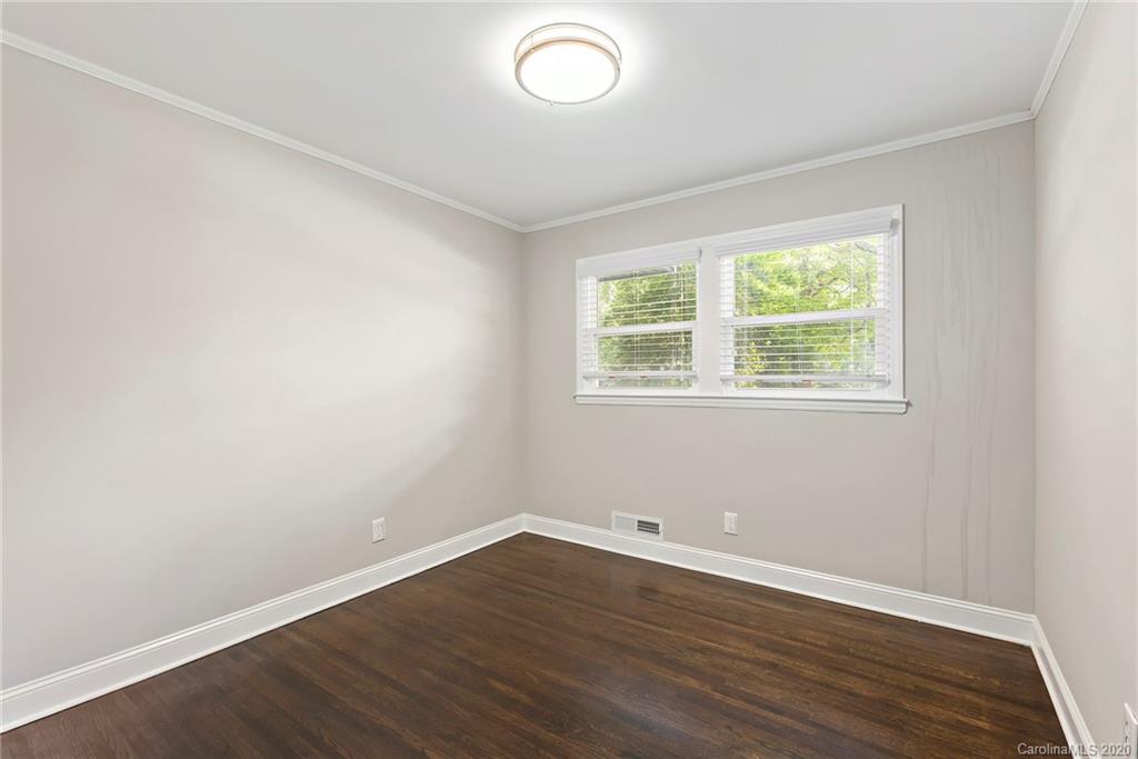 3115 Sudbury Road Charlotte, NC 28205 - Photo 9 of 17 an empty room with wooden floor and windows
