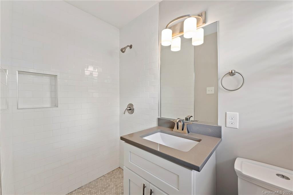 3115 Sudbury Road Charlotte, NC 28205 - Photo 10 of 17 a bathroom with a sink and a mirror