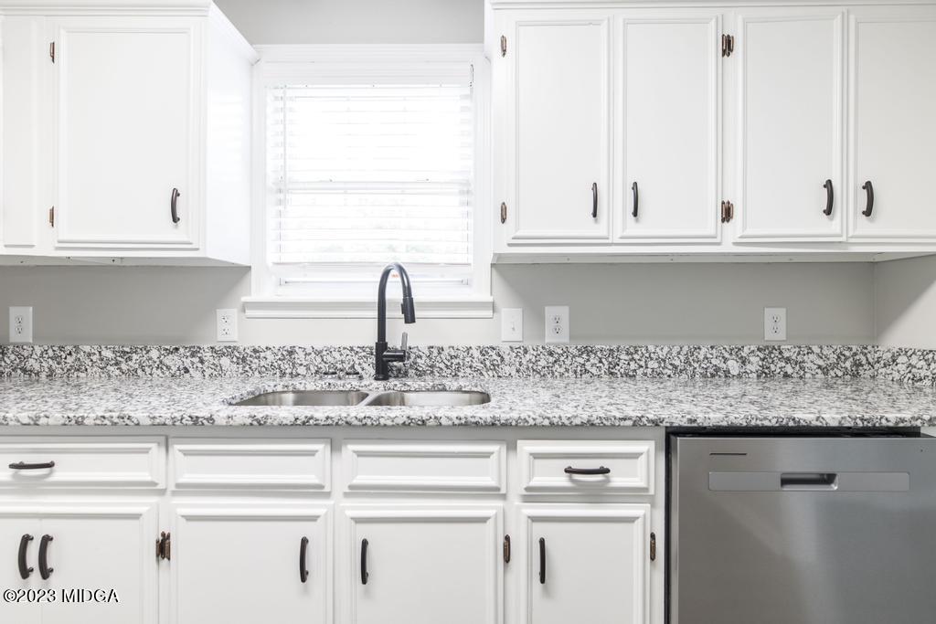 1734 Dixon Road Roberta, GA 31078 - Photo 11 of 40 a kitchen with granite countertop white cabinets and a window