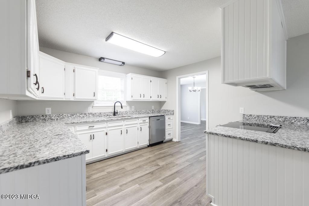 1734 Dixon Road Roberta, GA 31078 - Photo 13 of 40 a kitchen with granite countertop cabinets sink and stainless steel appliances
