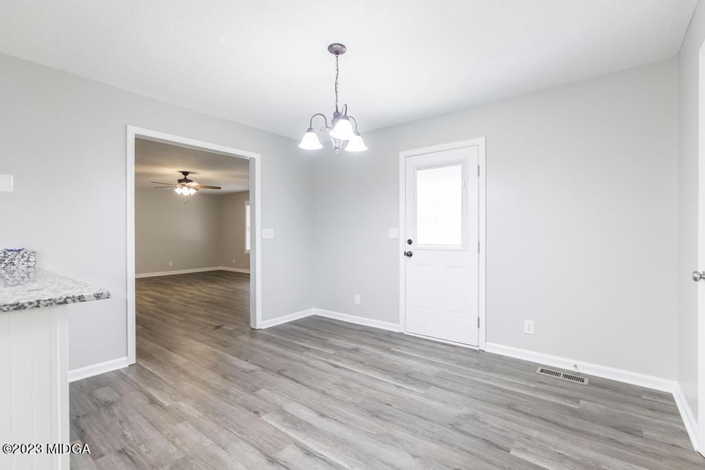 1734 Dixon Road Roberta, GA 31078 - Photo 14 of 40 an empty room with wooden floor and bathroom