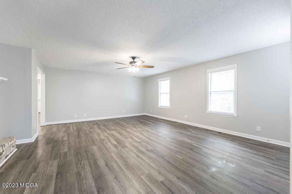 1734 Dixon Road Roberta, GA 31078 - Photo 16 of 40 a view of an empty room with wooden floor and a window