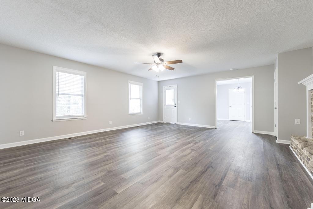 1734 Dixon Road Roberta, GA 31078 - Photo 18 of 40 a view of an empty room with a window and wooden floor