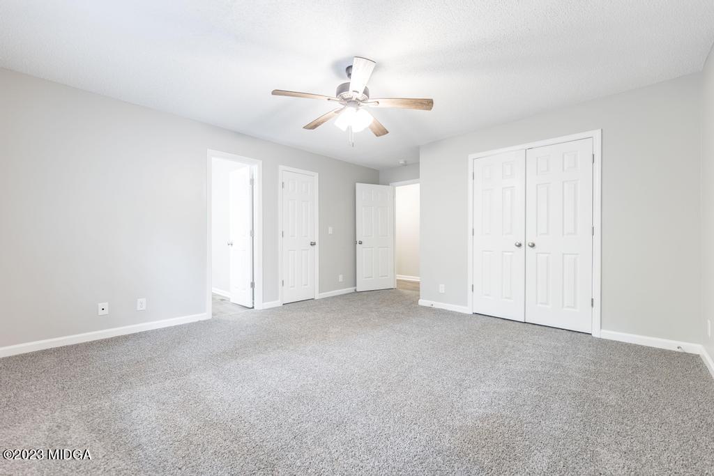 1734 Dixon Road Roberta, GA 31078 - Photo 27 of 40 an empty room with chandelier fan and windows