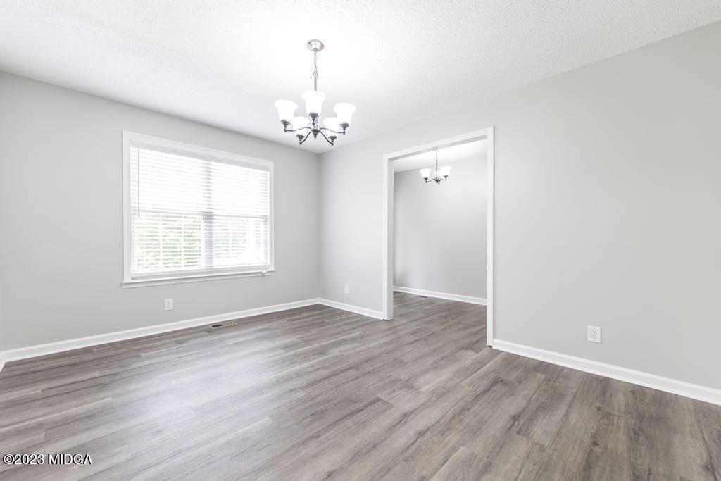 1734 Dixon Road Roberta, GA 31078 - Photo 9 of 40 an empty room with wooden floor and windows