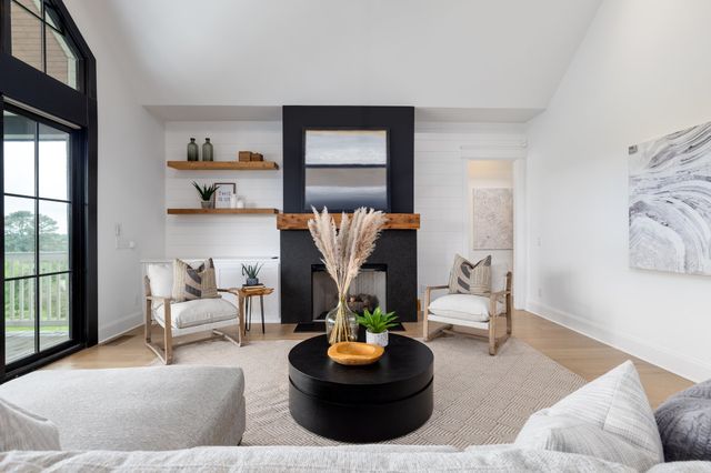 a living room with furniture and a floor to ceiling window
