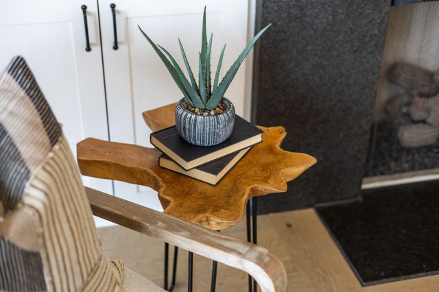 a kitchen with stainless steel appliances a stove a sink a center island and a wooden floor