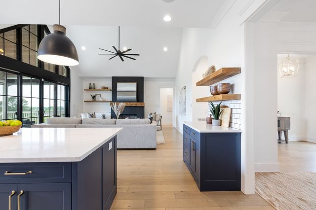 a kitchen with stainless steel appliances granite countertop a sink a stove and a center island