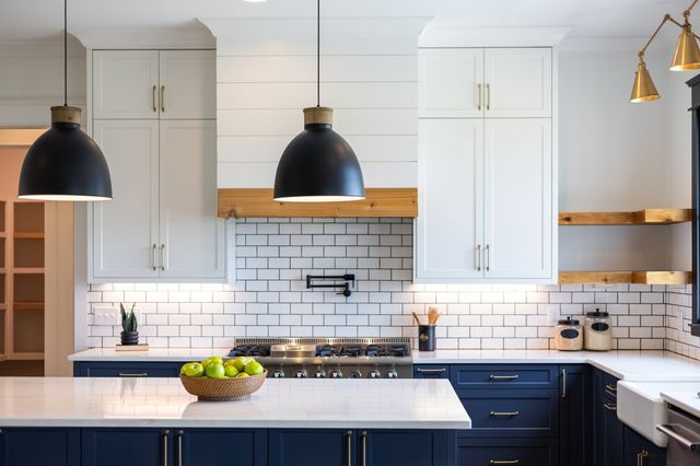 a large kitchen with stainless steel appliances granite countertop a stove a sink a refrigerator and a dining table with wooden floor