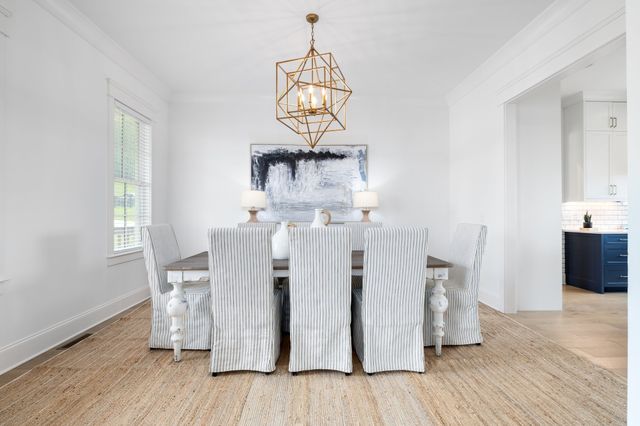 a living room with furniture a fireplace and a large window