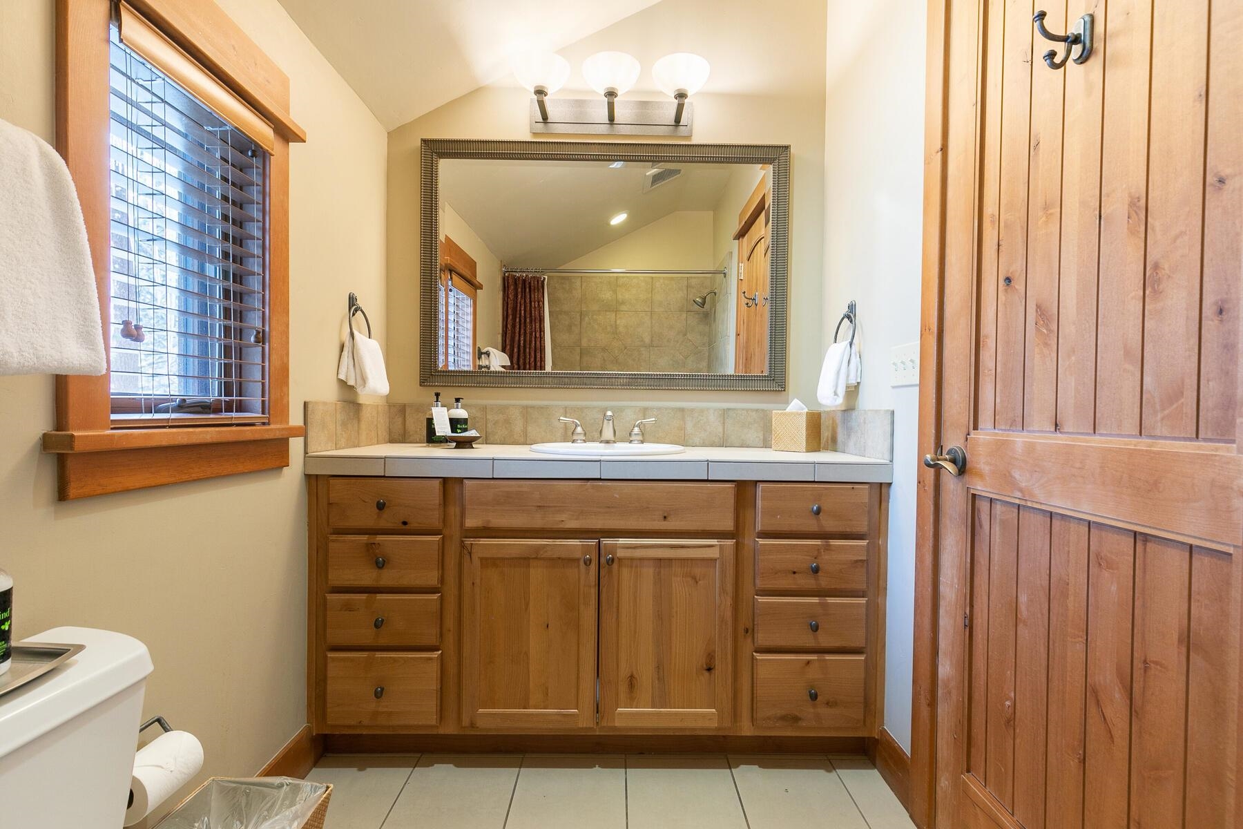 12193 Lookout Loop, Unit F0301 Truckee, CA 96161 - Photo 14 of 26 a bathroom with a sink a toilet and a mirror