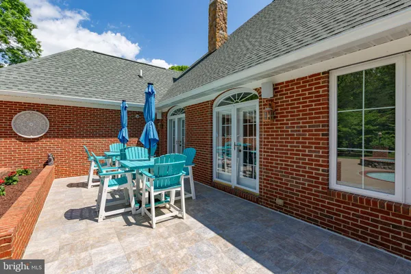 a view of a house with swimming pool and sitting area