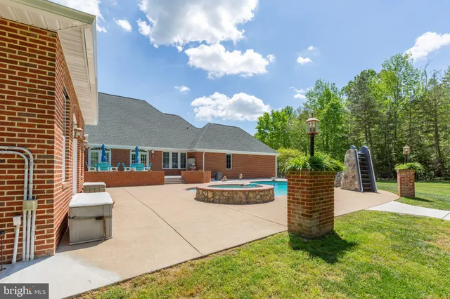 an aerial view of a house with yard swimming pool and outdoor seating