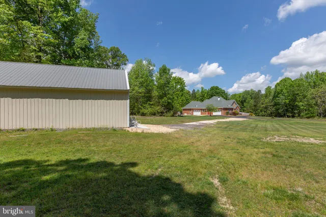 an aerial view of a house with outdoor space swimming pool and mountains