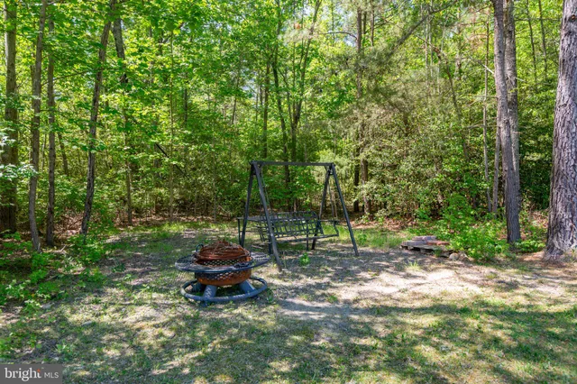 an aerial view of a house with a yard and garden