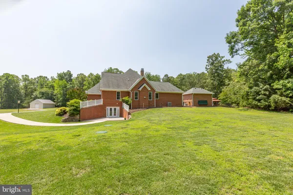 an aerial view of a house with a yard and trees