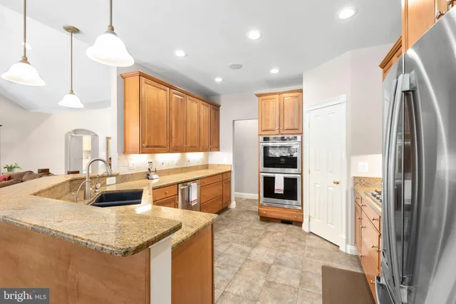 a spacious bedroom with a bed and a flat screen tv