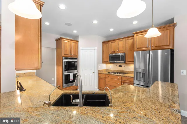 a spacious bedroom with a bed and a flat screen tv