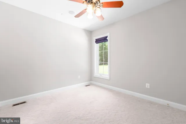 a kitchen with stainless steel appliances a stove a sink and a refrigerator with wooden floors