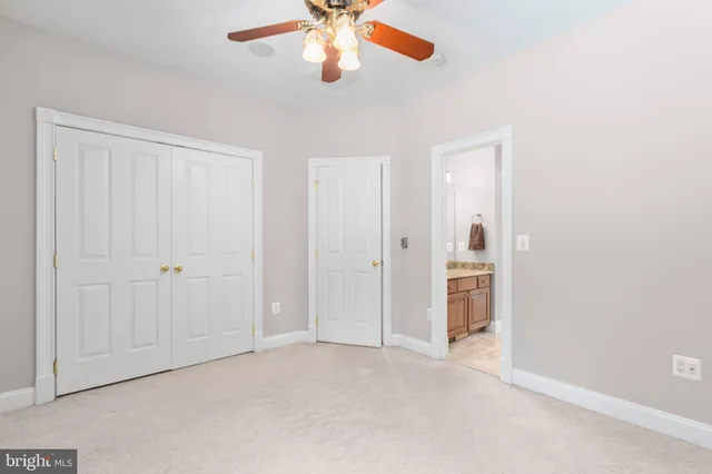 a view of an empty room with furniture and a window